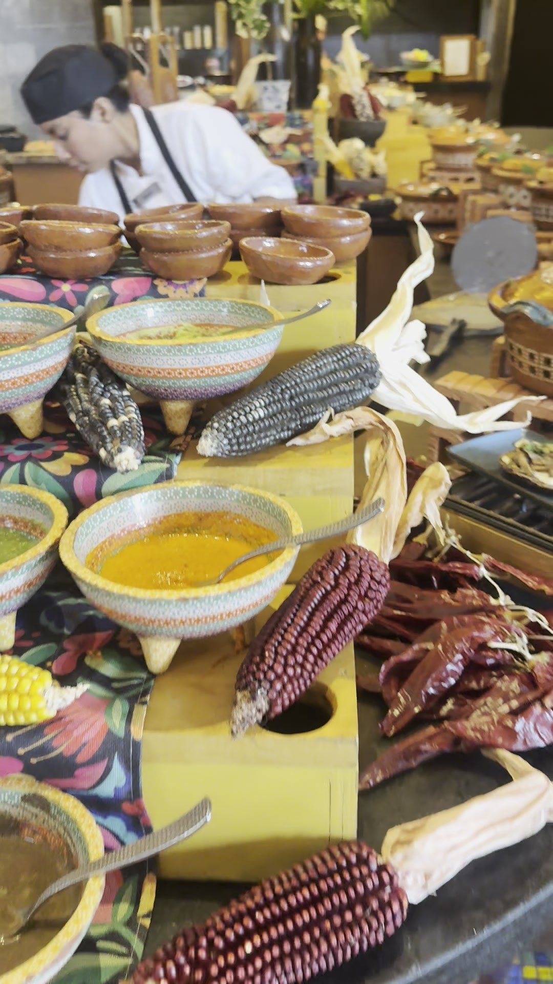 Salsas in painted clay bowls alongside heirloom corn and dried chiles at the Oriente breakfast buffet