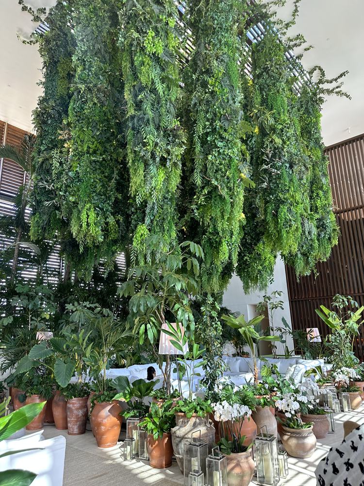 Two-storey living green wall above terracotta pots in the EDITION lobby