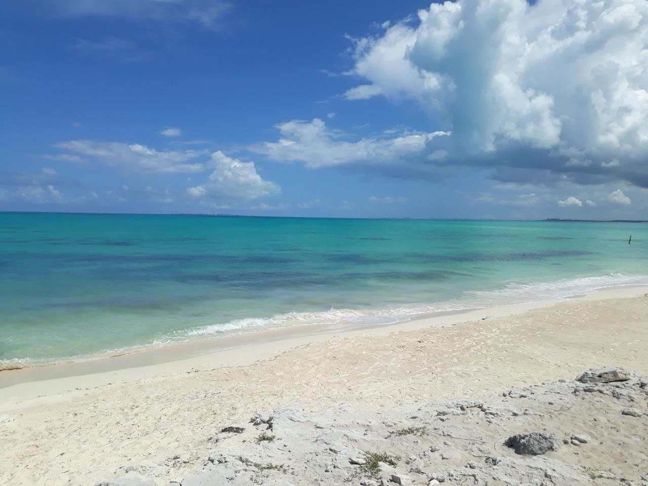 Empty white sand beach and turquoise water at Isla Blanca