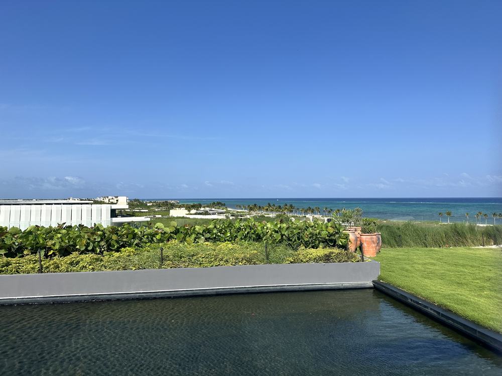 Rooftop terrace at Kanai with a reflecting pool looking over dune planting toward the Caribbean